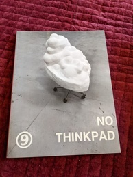Cover of the 9front Dash 1 manual, NO THINKPAD edition. Features a sculpture that resembles a pile of whipped cream perched on casters that appear to be from an office chair. The 9front logo is in the bottom-left corner