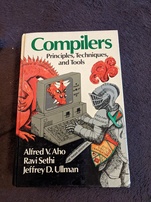 Compilers - Principles, Techniques, and Tools. Features a knight fully clad in armor that is labeled 'Data Flow Analysis' using a computer where a dragon labeled 'Complexity of Compiler Design' has stuck its head through the back of the monitor and is glaring at the knight through the glass