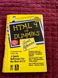 HTML 4 for Dummies book cover. Book is mostly yellow and black and is comb bound. Has a drawing of a Post-It note that says 'Quick Reference'. Features a lot of quotes from book reviewers