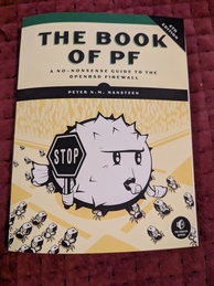 The Book of PF, fourth edition. Features a pufferfish holding a STOP sign and blowing a whistle as if directing traffic