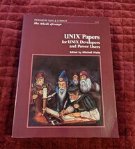Cover of the UNIX Papers for UNIX Developers and Power Users book by the Waite Group. Features a drawing of five old men in elaborate robes decorated with scallop shells. One man is seated at a desk writing using a quill and has an inkwell of glowing green ink. There is an open book in front of him and several papers scattered around. The rest of the men look on with one man holding an open book and a rod of some kind