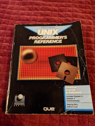 UNIX Programmer's Reference book cover. Features a grid of red squares with a border of yellow squares. Overlaid on top of the grid is an image of three 5.25'' floppy disks and a sphere